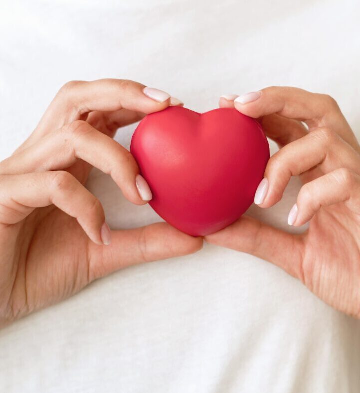 front-view-woman-holding-heart-shape