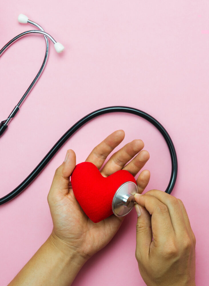 Table top view aerial image of accessories healthcare & medical with Valentines day background concept.Flat lay items for doctor using telescope checking heart rate colorful love shape on pink paper.